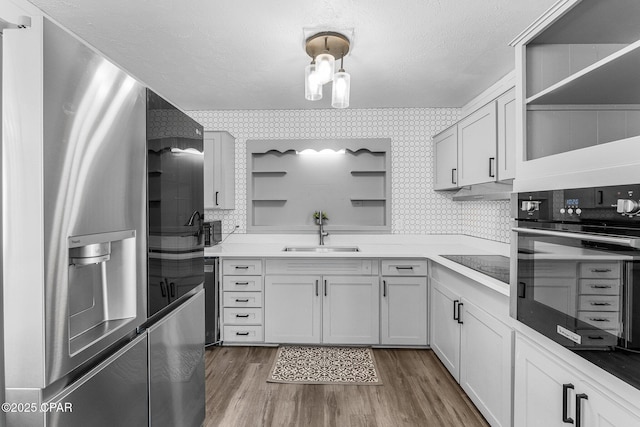 kitchen with white cabinets, sink, and black appliances