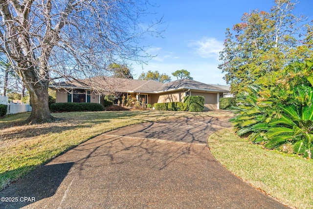 ranch-style house with a front lawn