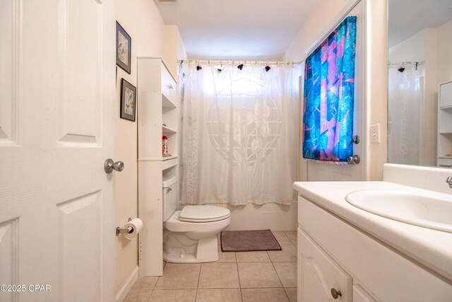 full bathroom featuring tile patterned floors, toilet, shower / bath combo with shower curtain, and vanity