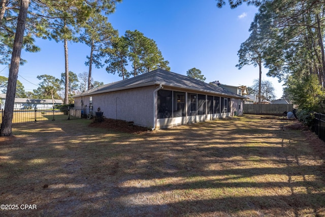 view of home's exterior featuring a yard and a sunroom