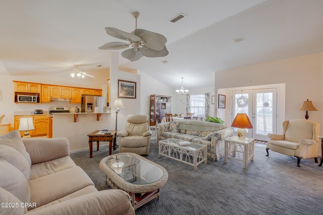 carpeted living room with ceiling fan with notable chandelier, vaulted ceiling, and french doors