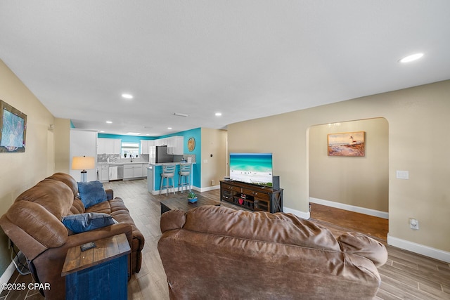 living room featuring sink and light wood-type flooring