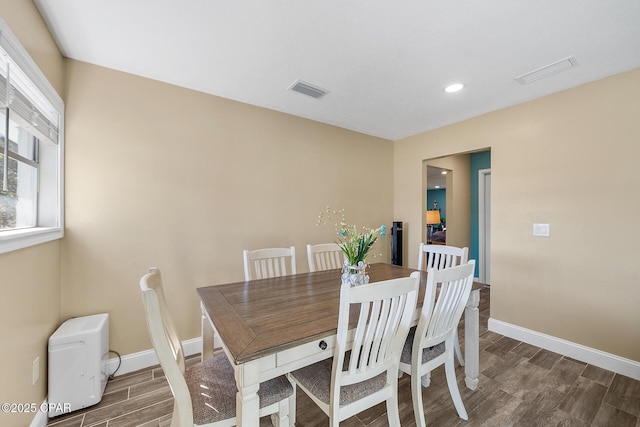 dining room featuring a wealth of natural light and dark hardwood / wood-style flooring