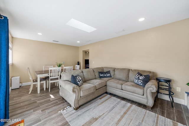 living room featuring a skylight