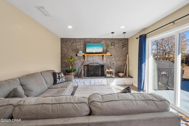 living room featuring a stone fireplace