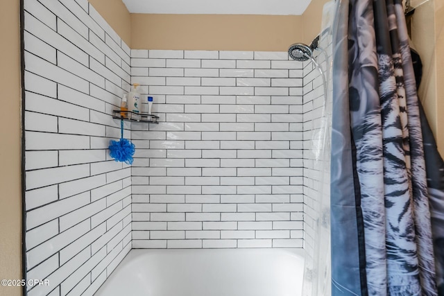 bathroom with shower / bath combo with shower curtain