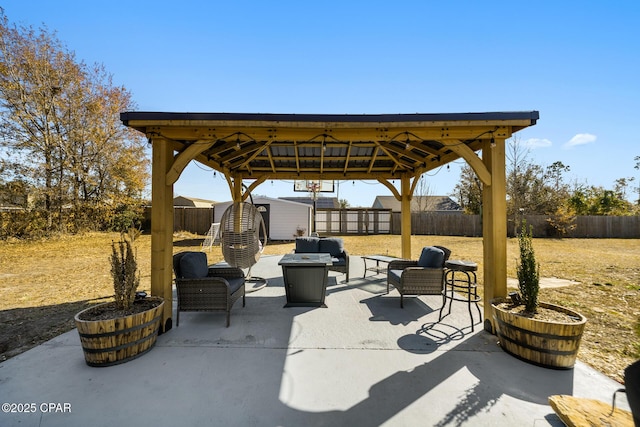 view of patio featuring a gazebo, outdoor lounge area, and a storage unit