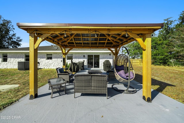 view of patio featuring cooling unit, outdoor lounge area, and a gazebo