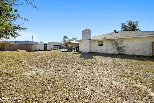 view of yard with a gazebo and a storage unit