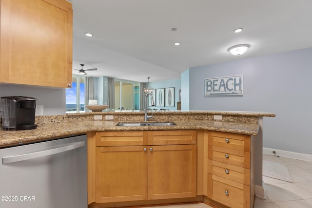 kitchen with sink, light stone counters, light tile patterned floors, stainless steel dishwasher, and kitchen peninsula