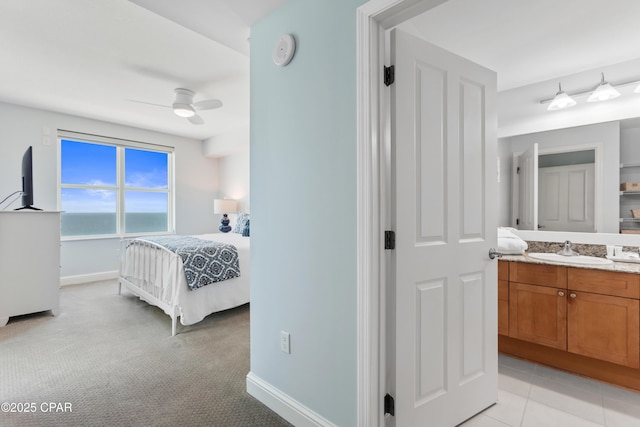 bedroom featuring sink and light carpet