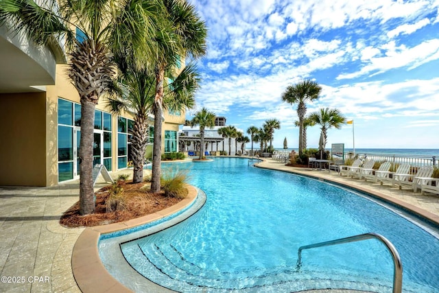 view of pool featuring a patio, a water view, and a pergola