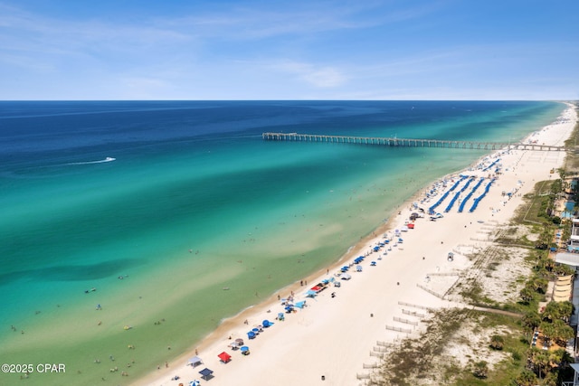 drone / aerial view with a water view and a beach view