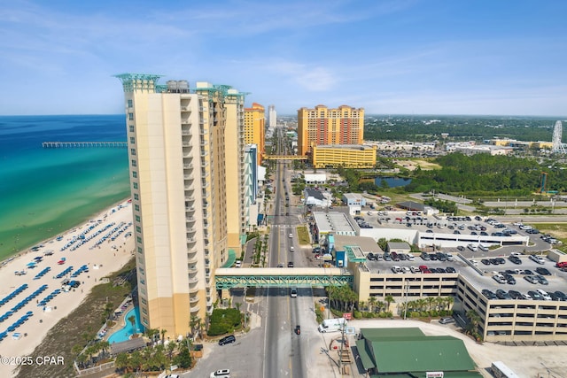 drone / aerial view featuring a water view and a beach view