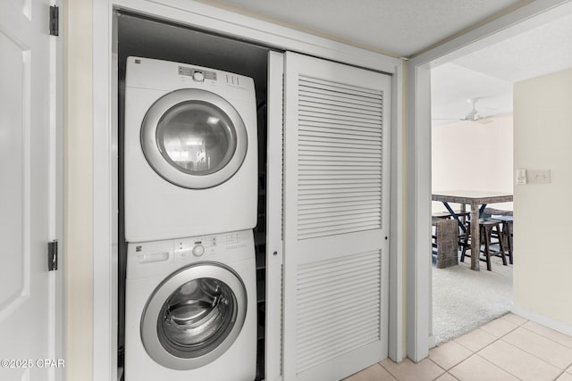 4600 Kingfish Ln Unit 508, Panama City, FL 32408 - clothes washing area with stacked washing machine and dryer, light tile patterned floors, and light carpet