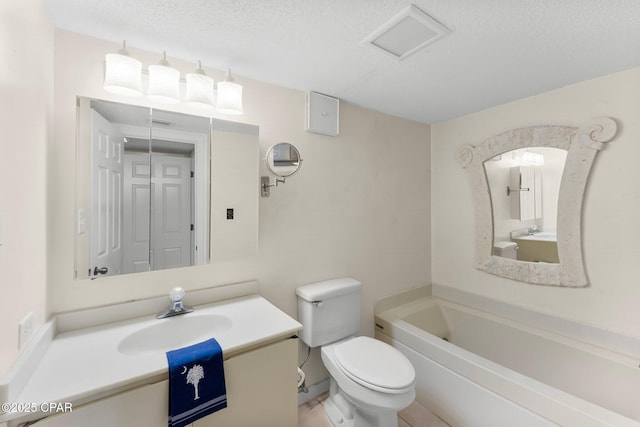 bathroom featuring a textured ceiling, vanity, and toilet