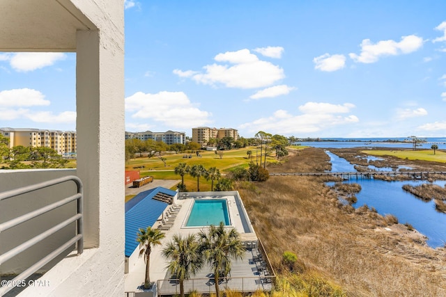 view of swimming pool with a water view