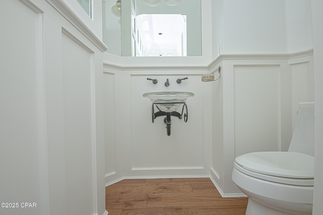 bathroom featuring hardwood / wood-style flooring and toilet