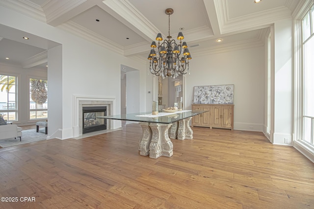 dining room featuring plenty of natural light, ornamental molding, beamed ceiling, and light wood-type flooring