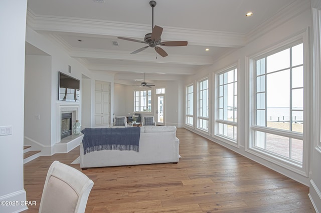 living room with beamed ceiling, crown molding, and hardwood / wood-style flooring