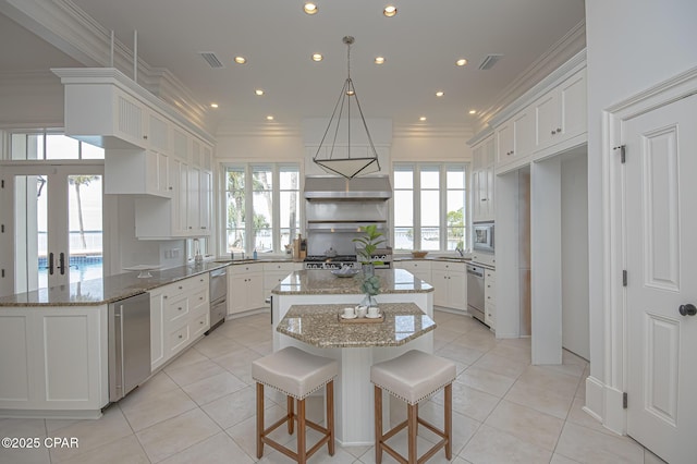 kitchen with white cabinetry, appliances with stainless steel finishes, and french doors