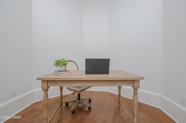 home office with hardwood / wood-style flooring