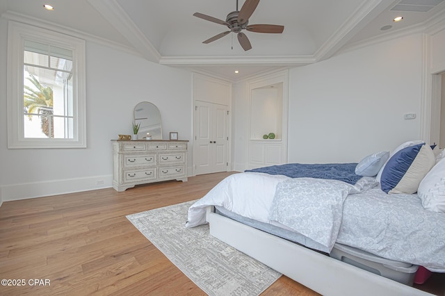 bedroom with crown molding, ceiling fan, light hardwood / wood-style floors, and a closet