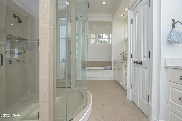 bathroom featuring independent shower and bath, vanity, ornamental molding, and tile patterned floors