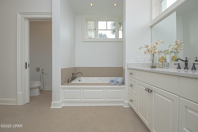 bathroom featuring vanity, tile patterned floors, a tub, and toilet