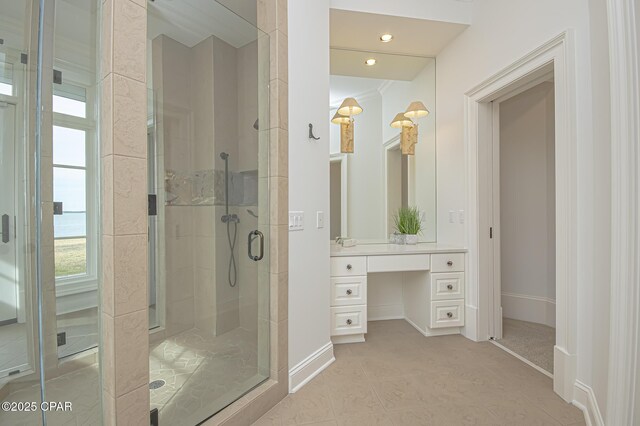 bathroom with vanity and a shower with shower door