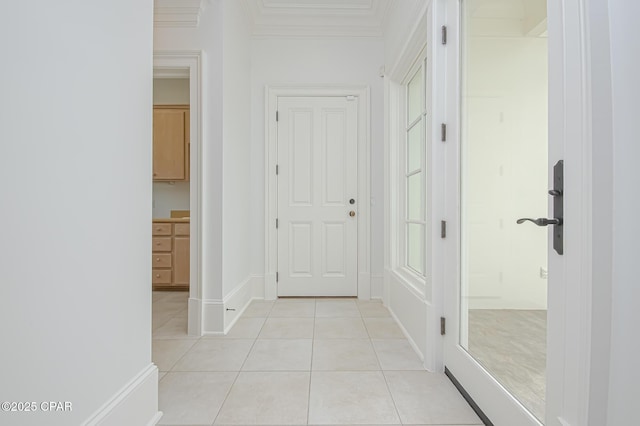 hallway featuring crown molding and light tile patterned floors