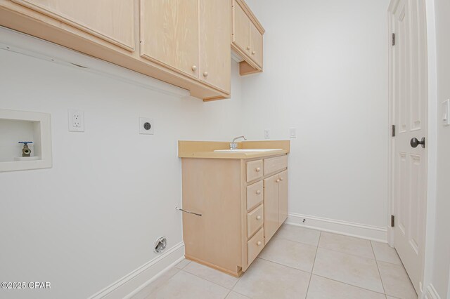 laundry area with sink, hookup for a washing machine, cabinets, light tile patterned flooring, and hookup for an electric dryer