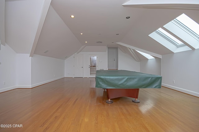 recreation room with billiards, vaulted ceiling with skylight, and light hardwood / wood-style floors