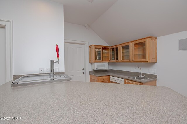 kitchen with light brown cabinetry, sink, vaulted ceiling, kitchen peninsula, and white appliances