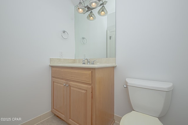 bathroom with vanity, toilet, and tile patterned flooring