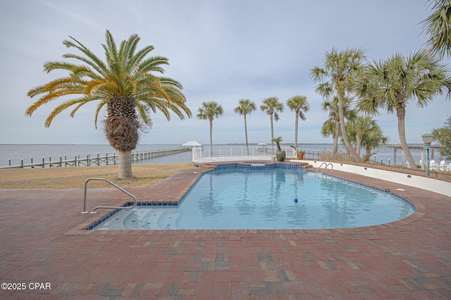 view of swimming pool with a water view