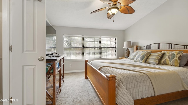 carpeted bedroom with vaulted ceiling and ceiling fan