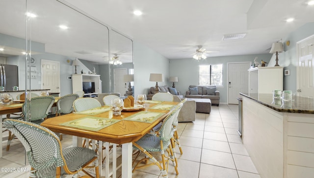 dining space featuring light tile patterned flooring and ceiling fan