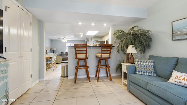 tiled living room with ceiling fan