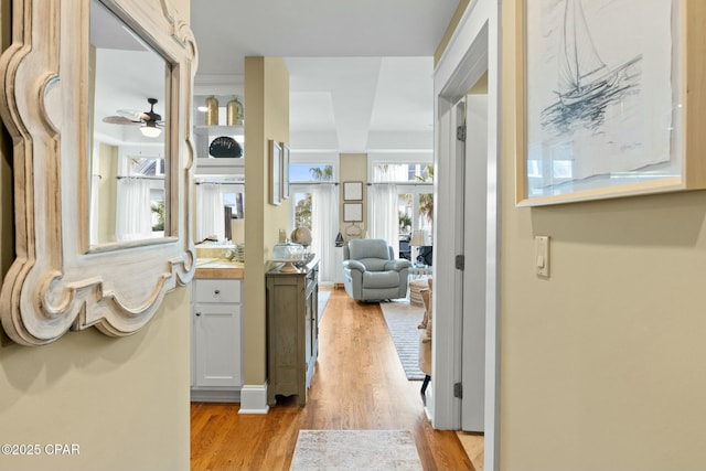 corridor with light hardwood / wood-style flooring