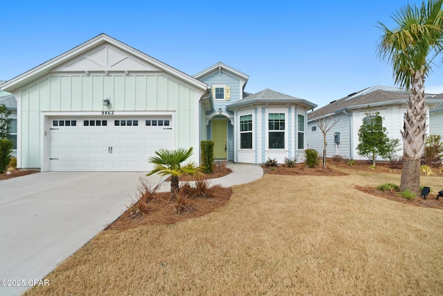 view of front of home with a garage and a front lawn