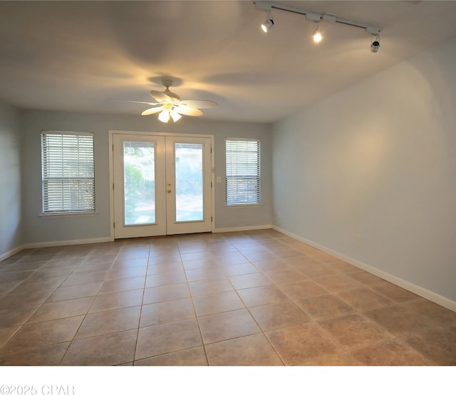 interior space with tile patterned flooring, baseboards, a wealth of natural light, and french doors