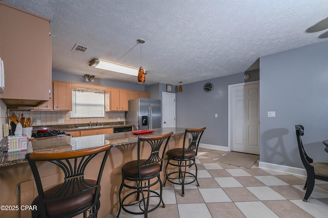 kitchen with sink, stainless steel fridge with ice dispenser, black dishwasher, kitchen peninsula, and backsplash