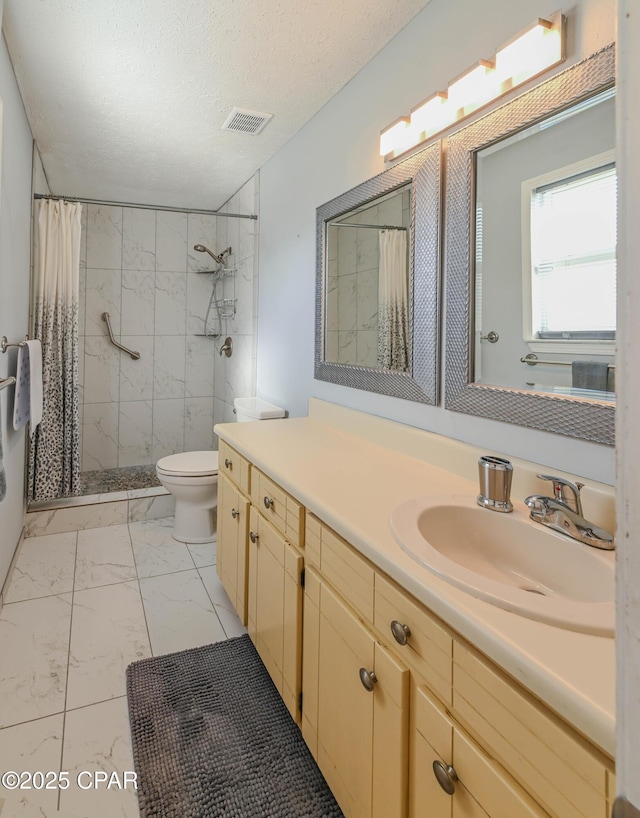 bathroom featuring vanity, toilet, a textured ceiling, and walk in shower