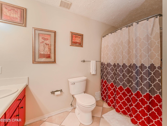 bathroom with vanity, tile patterned floors, a textured ceiling, and toilet