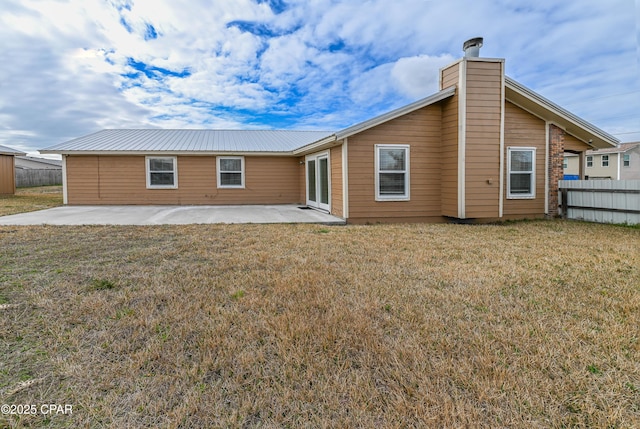 rear view of house featuring a patio and a lawn