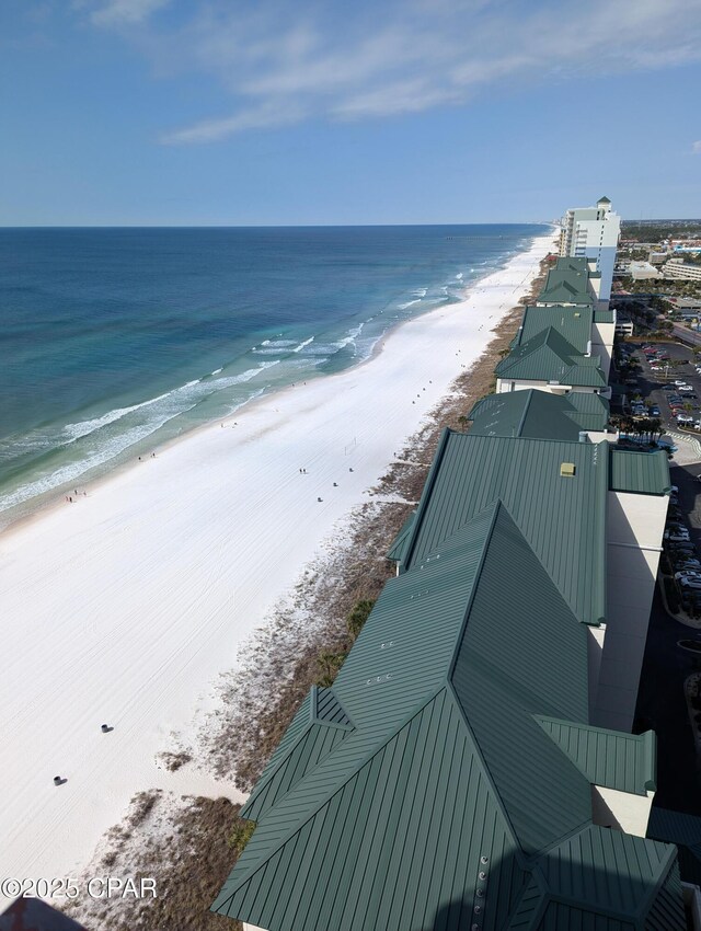 birds eye view of property with a beach view and a water view