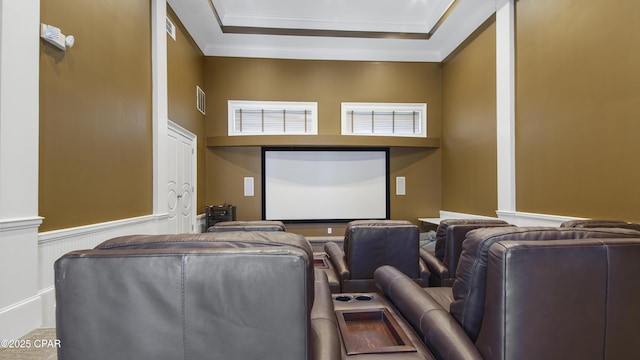 home theater featuring ornamental molding and a tray ceiling