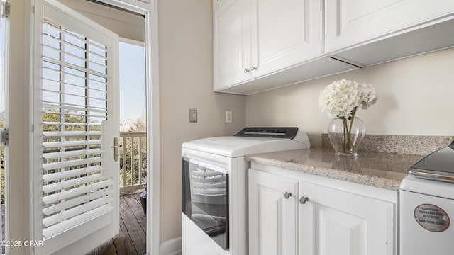 laundry area with cabinets and washer and clothes dryer