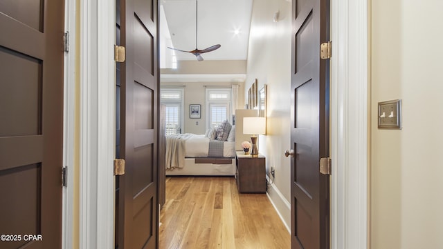 corridor with light hardwood / wood-style floors